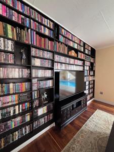 a living room with a large wall of dvds at Hyalus House in Vaal Marina
