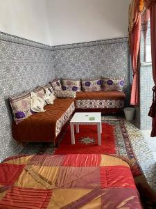 a living room with a couch and a table at Cosy Riad Cœur Medina in Rabat