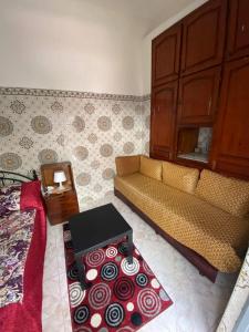 a living room with a couch and a table at Cosy Riad Cœur Medina in Rabat
