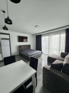 a living room with a couch and a bed at CoyrtYard Longbeach Bölgesi İskele Mersin via 10 Cyprus 99850 TRNC Iskele in Iskele