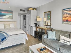 a living room with a bed and a couch at Pirates Bay B303 in Fort Walton Beach +49 photos