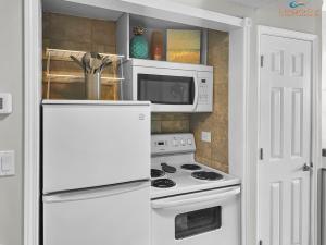 a kitchen with a white stove and a microwave at Pirates Bay B303 in Fort Walton Beach
