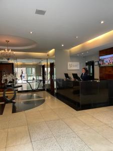 a person sitting at a desk in a lobby at Sequoia - Alphaville in Barueri +19 photos