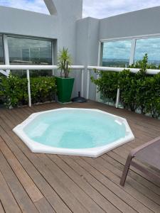 a hot tub on the deck of a house at Sequoia - Alphaville in Barueri