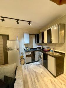 a kitchen with stainless steel appliances and a couch at Ras Sedr in Ras Sedr