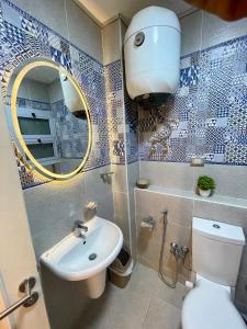 a bathroom with a toilet and a sink and a mirror at Ras Sedr in Ras Sedr