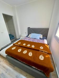 a bed with two blankets on it in a room at Ras Sedr in Ras Sedr