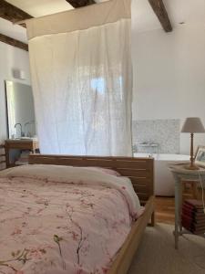 a bedroom with a bed with a canopy and a window at Ker Gwezenn in Tramain