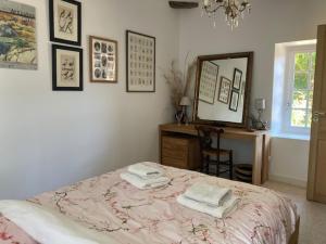 a bedroom with a bed and a mirror and a desk at Ker Gwezenn in Tramain +6 photos