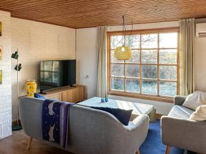 a living room with a couch and a tv at 4 person holiday home in Aars-By Traum in Års