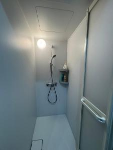 a bathroom with a shower with a shower head at Kurmon Inn in Omachi +47 photos