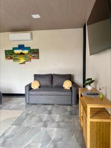 a living room with a couch and a table at Arenal Star Luxury Studios with Private Jacuzzi in Fortuna