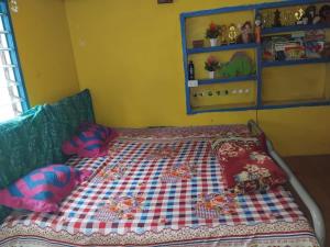 a bed with pillows on it in a room at Salote homestay in Lautoka