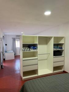 a room with a bed and a white cabinet at Bruma in Leones +1 photo