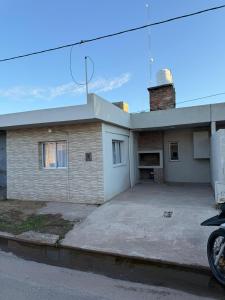 a house with a parking lot in front of it at Bruma in Leones