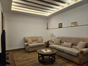 a living room with two couches and a table at En Ca La Abuela Casa Rural in Consuegra +37 photos