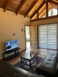 a living room with a couch and a coffee table at Casa familiar en parcela privada Pucón in Pucón