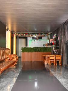 a restaurant with a bar with a table and chairs at Hotel Ostatus in El Pangui