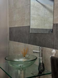 a bathroom with a glass sink and a mirror at Tandem - Espacio para dos - Cama King - Parking in Maipú +23 photos