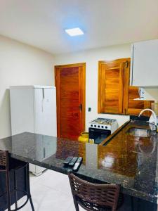 a kitchen with a counter top and a refrigerator at Bigorú Flats in Itacaré