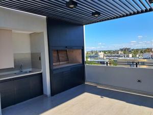 a large kitchen with a view of a city at Edificio Domum Urquiza 134 in San Juan