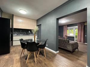 a kitchen and dining room with a table and a couch at Villa Luxury Crystal center in Bihać