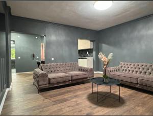 a living room with two couches and a table at Villa Luxury Crystal center in Bihać