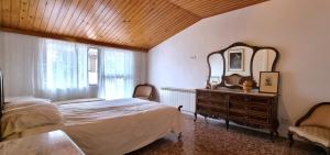 a bedroom with a bed and a dresser and a mirror at Las raíces de los abuelos in Guadalix de la Sierra
