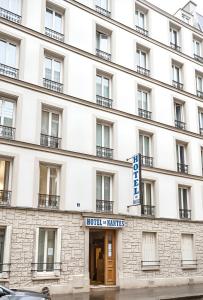 a large white building with a sign on it at Hotel de Nantes in Paris