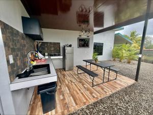 a kitchen with a counter and a table and a sink at Arenal Star Luxury Studios with Private Jacuzzi in Fortuna