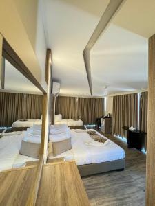 a hotel room with two beds with white sheets at Alena Boutique Hotel in Aqaba +59 photos