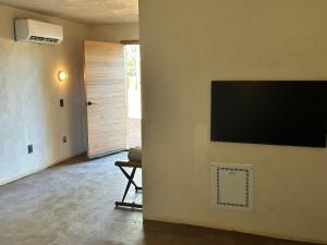 a living room with a flat screen tv on a wall at Kit Inn Wetrock in Moab