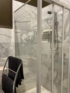 a shower with a glass door in a bathroom at Bromwich Guest House - 250m to town centre! in Blackwood +38 photos