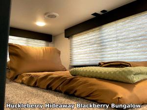 a bedroom with a bed with a large window at Huckleberry Hideaway in Minden