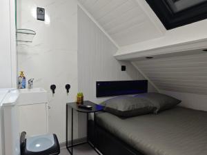 a bedroom with a bed and a sink and a table at Budget-Room 2p in Ostend +5 photos