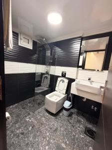 a bathroom with a toilet and a sink at ZORA Suites hotel in Jounieh +57 photos