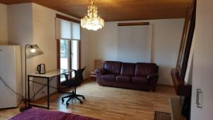 a living room with a couch and a table at room for rent in Bolligen