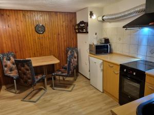 a kitchen with a table and chairs and a microwave at Blacksmith in Kropa