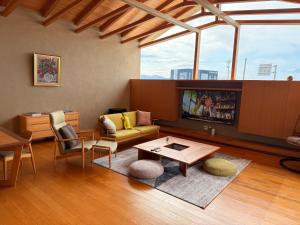 a living room with a couch and a table at the Mikuni Residence in Sakai
