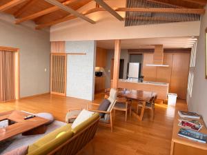 a living room with a couch and a table at the Mikuni Residence in Sakai