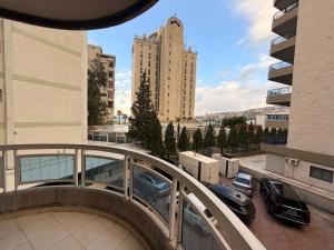 a view of a building with cars parked on a balcony at ZORA Suites hotel in Jounieh