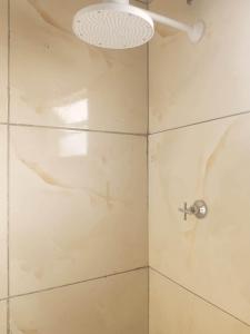 a bathroom with a shower with a glass door at Próximo do carnaval em Olinda in Olinda