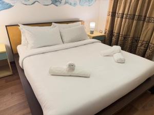 a bedroom with a bed with two towels on it at Victoria guesthouse in Rome