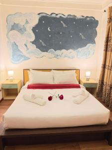 a bed with two glasses and a painting on the wall at Victoria guesthouse in Rome +14 photos