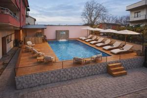 a swimming pool with lounge chairs at Villa & Apartments Antigona in Ohrid