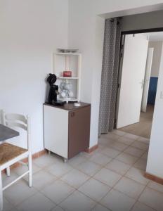 a kitchen with a table and a chair in a room at Iduski in Saint-Pée-sur-Nivelle