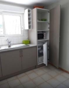 a small kitchen with a sink and a microwave at Iduski in Saint-Pée-sur-Nivelle