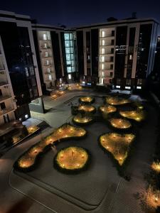 a courtyard with lights in a large building at night at White Guest House in Samarkand