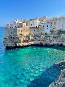 a group of buildings on top of the water at Alba e Colori di Puglia in Conversano