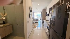 a kitchen with a sink and a stove top oven at Apartamento tipo Loft in Gaira